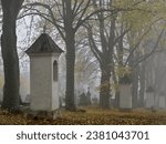 Melancholic mood in a foggy old Christian cemetery. The road through Calvary.