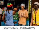 Small photo of St Andrew, Jamaica January 01, 2022: Rastafatian Reggae Artiste Jah Izrehl parades through a poor people market in Papine Jamaica