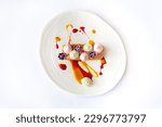 Carrot cake with berry mousse on a white plate isolated