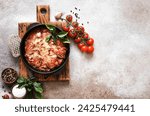 Small photo of Casserole with eggplant, tomato sauce and cheese, top view, with space for text. Moussaka.