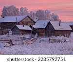 winter villages are covered with snow pink sunset trees sky