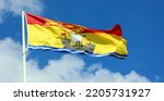 Small photo of The flag of New Brunswick consists of a golden lion passant on a red field in the upper third and a gold field defaced with a lymphad on top of blue and white wavy lines in the bottom two-thirds.