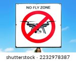 No fly zone sign against a blue sky background. No drone zone sign