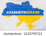 Small photo of RIGA, LATVIA. 17th February 2022. Selective focus photo. Stand With Ukraine slogan, during Ukraine Week event near Monument of Freedom in Riga.