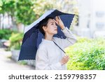 Small photo of Asian woman with a parasol