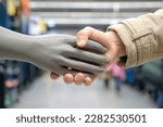 Small photo of A handshake with a plastic dummy . The concept of man versus artificial intelligence is friendship or enmity, help with work or unemployment. AI generated generation.