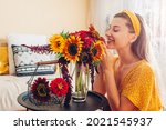 Woman Smells Bouquet Of...