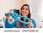 Heatless hair curler. Close up portrait of young woman doing hair at home using headband and claw clip. Beauty products for hairstyle.