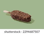 Chocolate ice cream on a stick green pastel background