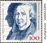 Small photo of MADRID, SPAIN - FEBRUARY 2, 2020. Vintage stamp printed in Germany shows Matthias Claudius, a German poet and journalist, otherwise known by the pen name of “Asmus”