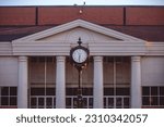 Small photo of Troy, AL, USA - March 30th, 2023: Beautiful clock in front of a building at Troy University campus in honor of Jack Hawkins Jr.