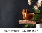 Small photo of New zealand manuka honey dripping from a honey dipper