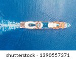 Cruise liner ship in ocean with blue water. Aerial top view.