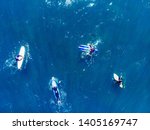 Small photo of Group of novice surfers are learning to embark on wave. Aerial top view.