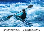 Whitewater kayaking, extreme sport rafting. Back view young woman in kayak sails mountain river.