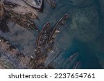 Remains of destroyed wooden ships after a battle or tsunami, Aerial top view. Dramatic photo concept of pirates.