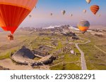 Small photo of Concept Travel Pamukkale Turkey. Hot air balloon flying Travertine pool ancient amphitheater.