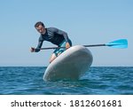 Man Surfing On Inflatable Stand ...