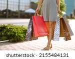 Shopping time. Young woman with shopping bags near the mall. Consumerism, sale, purchases, shopping, lifestyle concept. Summer.