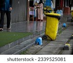 Small photo of Sentul, 23 July 2023 - A man throw away his thrash into a yellow rubbish bin Sentul Modern Market