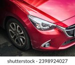 Small photo of Jakarta, 13 May 2023 - A man parked his red mazda 2 (DJ) sedan (DL) outside a pharmacy building in Kemayoran, Central Jakarta