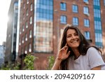 Beautiful young brunette on the background of the city. Happiness expression emotional  lifestyle portrait.