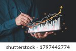 Small photo of Double Exposure businessman touch virtual screen displaying a crypto currency featuring tickers or graph. Stock chart showing rising stock sign with graph indicator. exchange market data candlesticks.