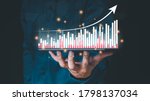 Small photo of ŕ¸şBusiness in Double Exposure touches a virtual screen that shows a crypto currency with tickers or a graph. With indication, a chart shows a rising stock symbol. candlesticks for market data exchange