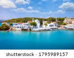 The cosmopolitan town of Porto Heli, Peloponnese, Greece, with a blue domed church and turquoise sea
