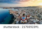 Panoramic aerial view of Ermoupoli city with the Saint Nicholas Church in front during a summer sunset, Syros island, Cyclades, Greece