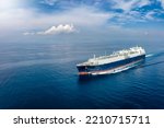 Small photo of Front view of a big LNG tanker ship travelling over the calm, blue ocean as a concept for international fuel industry with copy space