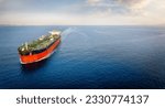 Small photo of Aerial view of a large crude oil tanker traveling over calm sea during sunset with copy space