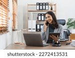 Small photo of Female lawyer works in office or court, checks clients contracts, Calling by phone. Asian successful business lady, statuette of Themis, goddess of justice. legal advice online.