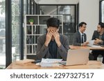 Small photo of business man at work on his laptop while suffering from a headache and anxiety with a working while struggling with fatigue stress
