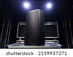 A sound speaker standing on boxes with concert equipment
