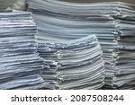 Small photo of bundles bales of paper documents. stacks packs pile on the desk in the office. waste paper, paper trash