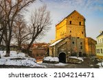 Small photo of Scenic view Kushnir (Furrier) Tower or Stephen Bathory's Tower - gateway of old city fortification, Kamianets-Podilskyi, Ukraine illuminated by sunset light