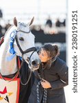 Small photo of Fair Hill, Maryland USA – October 22, 2023: Francesca Denning, groom for Colorado Blue, gives him a kiss during the prize giving ceremony at the 2023 MARS Maryland 5 Star at Fair Hill