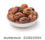 Small photo of Whole nutmegs with mace in ceramic bowl isolated on white