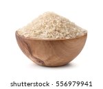  Uncooked dry rice in wooden bowl isolated on white