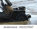 Small photo of military truck going ashore