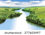 Zigzag river flows between summer valleys.a