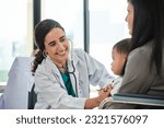 Small photo of Young female pediatric doctor teases little Asian boy before medical examination at outpatient clinic hospital, people public health care checkups, and appointment visits.