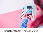 Small photo of young women taking photo to bags with cell telephone or smartphone digital camera for Post to sell Online on the Internet . Customise pastel bright colors tone .