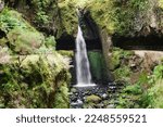 Small photo of Levada do Moinho. Incredible waterfall you can actually walk behind. Levada in Madeira, Portugal. Irrigation canal. Water canal. Waterfall at Levada do Moinho.