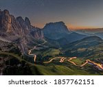 Nighttime image of the Gardena pass with stars and lighttrails in South Tyrol, the Italian Dolomites