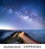 Astrophotography shot of hairpin turn with galactic core milky way rising on Madeira Island, Portugal