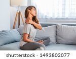 Small photo of Pain in the shoulder. Upper arm pain, People with body-muscles problem, Healthcare And Medicine concept. Attractive woman sitting on the bed and holding painful shoulder with another hand.