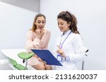 Small photo of Treatment of cervical disease. Female gynecologist unrecognizable woman patient in gynecological chair during gynecological check up. Gynecologist examines a woman. Diagnostic, medical service.