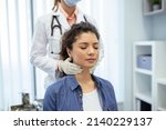 Small photo of Endocrinologist examining throat of young woman in clinic. Women with thyroid gland test . Endocrinology, hormones and treatment. Inflammation of the sore throat